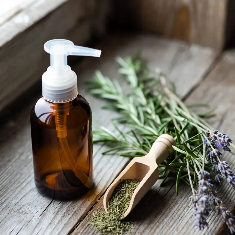 Amber pump bottle of natural anti-thinning shampoo with rosemary and lavender